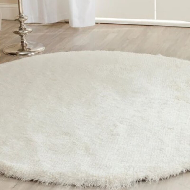 Safavieh Round Shag Rug
Cream
Size: 7'7x7'7
Handmade Paris Shag Danara rug, part of the Paris Shag Collection. Expertly hand-tufted with finely woven yarns, this plush shag rug boasts a 2.5-inch thick pile height that feels soft and cozy underfoot. The chic solid pattern and warm, solid hues effortlessly balance any living room or family room decor, while the shimmering, texture-rich finish adds a touch of glamour to your space.