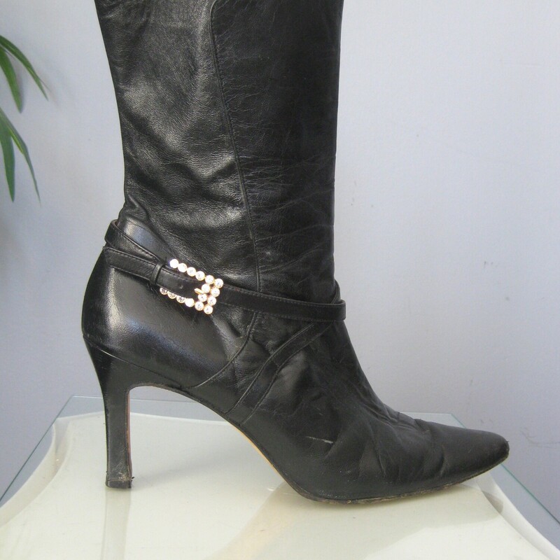 Beverly Leather Half, Black, Size: 9<br />
This is a pair of wickedly glamourous high heeled leather boots in black leather with red leather lining.  They're by Beverly Feldman.  Very high quality.<br />
They have side zippers and a leather strap decorated with a rhinestone buckle.<br />
marked size 9, which is my size and they fit me well.<br />
The heel is 3.5<br />
<br />
The boots are used. They  are in good to very good used condition, here are the things I've noticed:<br />
The pointy toes have some damage<br />
There is a marked at the top of the shaft of one boot.<br />
One of the rhinestone buckles is missing a stone<br />
The heels have some wear and possibly water damage.<br />
Please see all of my photos before purchasing.<br />
Happy to quickly respond to any questions.<br />
Priced accordingly<br />
<br />
Thanks for looking!<br />
#79150