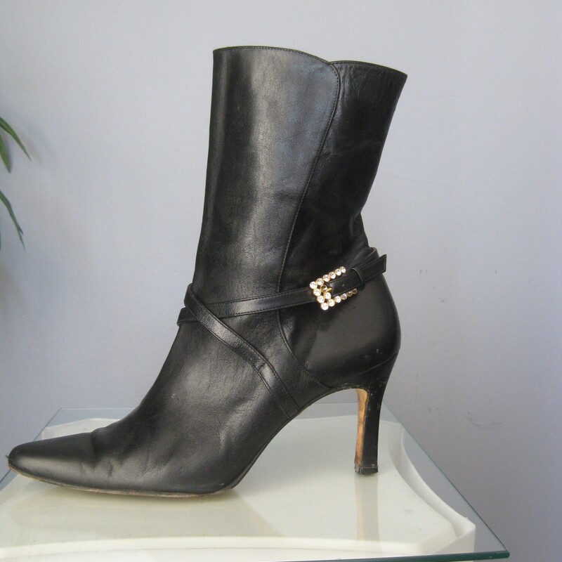 Beverly Leather Half, Black, Size: 9<br />
This is a pair of wickedly glamourous high heeled leather boots in black leather with red leather lining.  They're by Beverly Feldman.  Very high quality.<br />
They have side zippers and a leather strap decorated with a rhinestone buckle.<br />
marked size 9, which is my size and they fit me well.<br />
The heel is 3.5<br />
<br />
The boots are used. They  are in good to very good used condition, here are the things I've noticed:<br />
The pointy toes have some damage<br />
There is a marked at the top of the shaft of one boot.<br />
One of the rhinestone buckles is missing a stone<br />
The heels have some wear and possibly water damage.<br />
Please see all of my photos before purchasing.<br />
Happy to quickly respond to any questions.<br />
Priced accordingly<br />
<br />
Thanks for looking!<br />
#79150