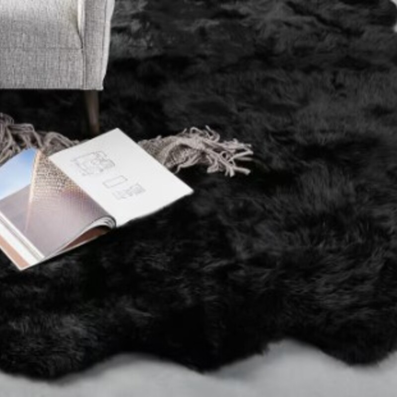 Arhaus Sheepskin Rug<br />
Black 100% Natural Sheepskin hide with leather back<br />
Size: 5'6x6'5 Weighs approximately 16 lbs.<br />
Retail $1299<br />
For regular cleaning, sheepskin rugs should be vacuumed lightly using handheld brushless attachments to prevent the pulling. Spills should be removed immediately by blotting with a clean, absorbent, white cloth, lukewarm water, and mild soap.After cleaning, blot dry with a towel or hang to dry. For heavy dirt or stains, scrub genrly with a brush and solution of one part mild liquid soap and ten parts water. Brush gently in the direction of the hair and allow to air dry.<br />
Retail