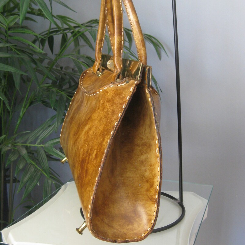 Vtg Manler Cali Structure, Brown, Size: None<br />
Roomy leather handbag with high end Western Style.  Made in California by Mahler.<br />
It's hard smooth glossy leather with sculpturing shaping at the top, light brown, tan in color with white top stitching.<br />
Strong gold hardware lines the top edge.<br />
It has a pass through clasp and unique brass feet that resemble the pommels of western saddles.<br />
Rawhide interior with a slip pocket made of vinyl.<br />
Amazing condition,<br />
The gold marking inside is partially worn away<br />
<br />
Measurements:<br />
Width: 15.5<br />
Height: 9.5<br />
Depth at bottom: 3.75<br />
Handle Drop: 4.75<br />
<br />
Thanks for looking!<br />
#78852