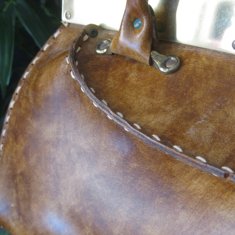 Vtg Manler Cali Structure, Brown, Size: None<br />
Roomy leather handbag with high end Western Style.  Made in California by Mahler.<br />
It's hard smooth glossy leather with sculpturing shaping at the top, light brown, tan in color with white top stitching.<br />
Strong gold hardware lines the top edge.<br />
It has a pass through clasp and unique brass feet that resemble the pommels of western saddles.<br />
Rawhide interior with a slip pocket made of vinyl.<br />
Amazing condition,<br />
The gold marking inside is partially worn away<br />
<br />
Measurements:<br />
Width: 15.5<br />
Height: 9.5<br />
Depth at bottom: 3.75<br />
Handle Drop: 4.75<br />
<br />
Thanks for looking!<br />
#78852