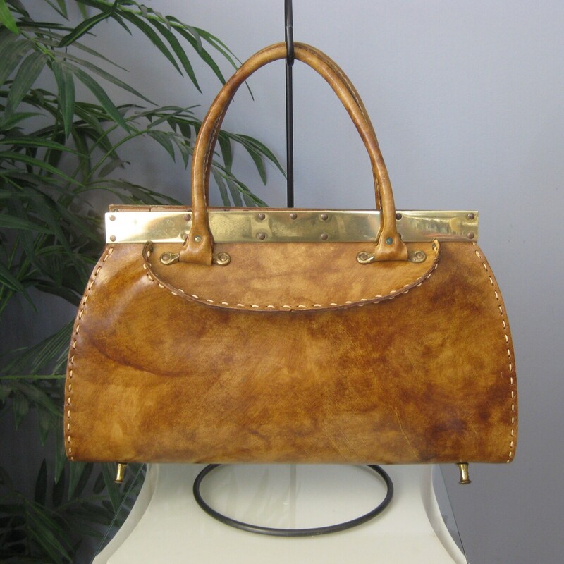 Vtg Manler Cali Structure, Brown, Size: None<br />
Roomy leather handbag with high end Western Style.  Made in California by Mahler.<br />
It's hard smooth glossy leather with sculpturing shaping at the top, light brown, tan in color with white top stitching.<br />
Strong gold hardware lines the top edge.<br />
It has a pass through clasp and unique brass feet that resemble the pommels of western saddles.<br />
Rawhide interior with a slip pocket made of vinyl.<br />
Amazing condition,<br />
The gold marking inside is partially worn away<br />
<br />
Measurements:<br />
Width: 15.5<br />
Height: 9.5<br />
Depth at bottom: 3.75<br />
Handle Drop: 4.75<br />
<br />
Thanks for looking!<br />
#78852