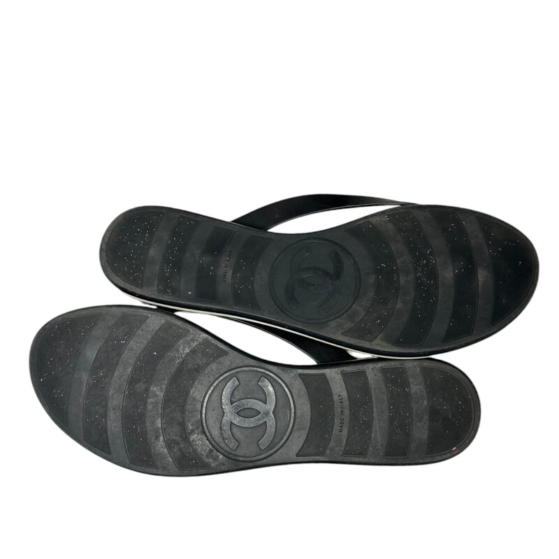 CHANEL Calfskin Rubber Thong Sandals  in Black. These  sandals are crafted of calfskin leather straps with small silver CC logos and soft, quilted lambskin insoles. They feature sturdy rubber soles and a white pinstripe along the circumference of each thong.
Code:FG30778