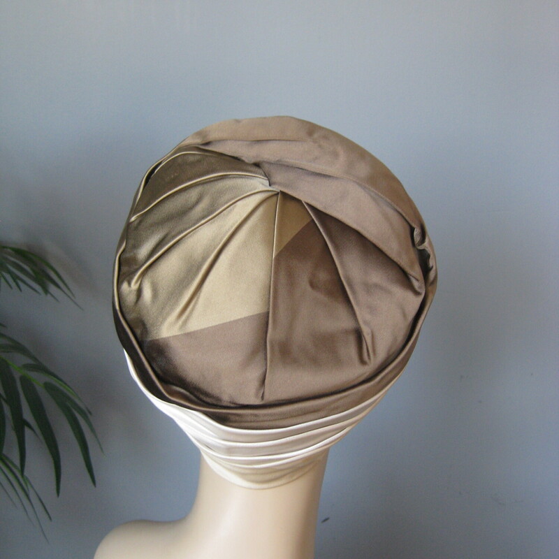 This dressy turban style hat is made of folded satin in shades of cream and taupe.<br />
By Mr John<br />
I found it at an estate sale in Norway Maine.<br />
Excellent vintage condition.<br />
Probably from the 1960s<br />
Inner hat band measures: 21.5<br />
Excellent condition, one faint stain as shown.<br />
<br />
Thank you for looking.<br />
#78414