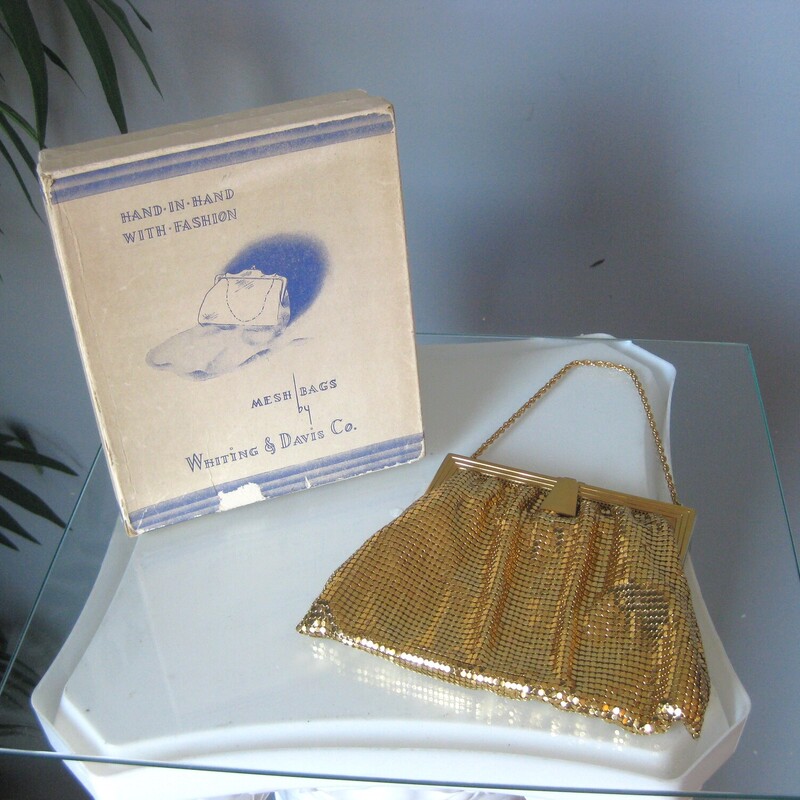 This gold mesh bag from Whiting and Davis is a classic and this one has never been used.<br />
It comes with its orginal gift box, the box is in ok shape, not perfect as you can see from my photos.<br />
<br />
It's got a matte gold metal frame with chain strap and brand markings<br />
The body of the bag is made of their patented gold mesh.<br />
Interior lined with satin<br />
5 wide<br />
7.5<br />
Thanks for looking!<br />
#72241