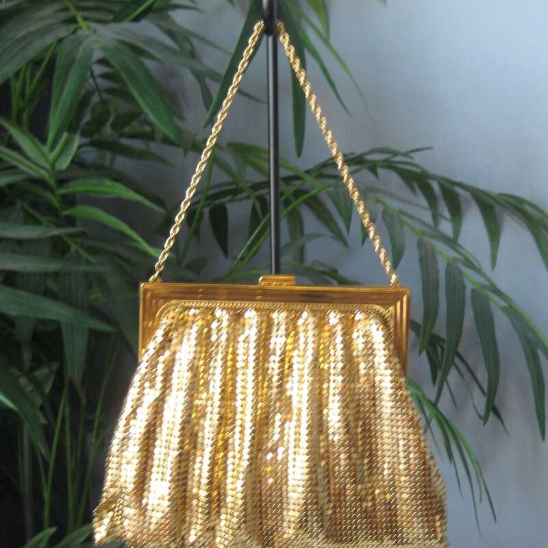 This gold mesh bag from Whiting and Davis is a classic and this one has never been used.<br />
It comes with its orginal gift box, the box is in ok shape, not perfect as you can see from my photos.<br />
<br />
It's got a matte gold metal frame with chain strap and brand markings<br />
The body of the bag is made of their patented gold mesh.<br />
Interior lined with satin<br />
5 wide<br />
7.5<br />
Thanks for looking!<br />
#72241