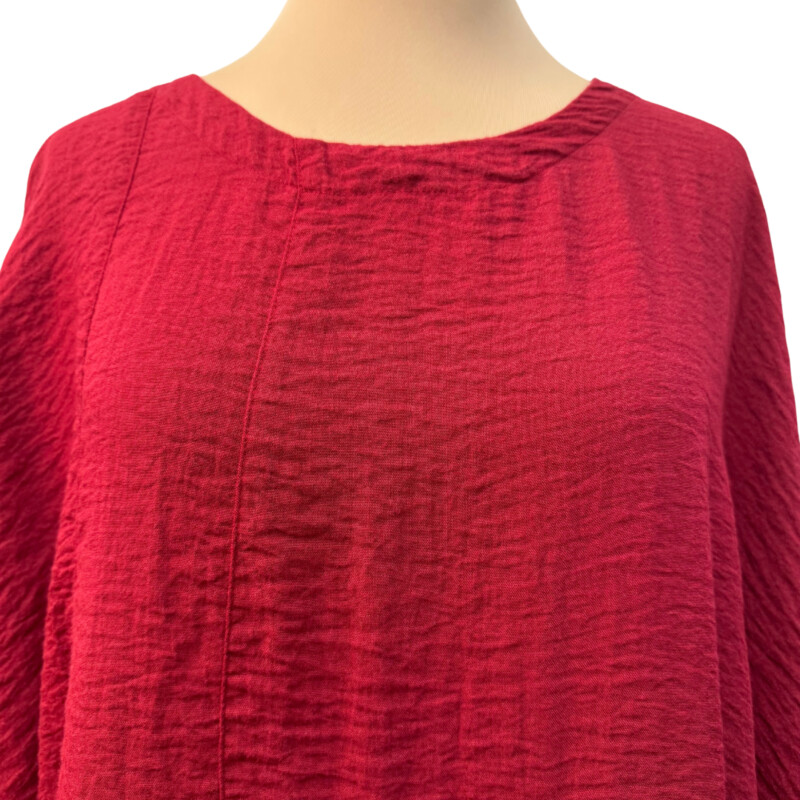 Eleven Stitch Crinkle Texture Dress<br />
3/4 sleeves<br />
Has pockets!<br />
Asymmetrical hem<br />
74% Rayon/26% Nylon<br />
Color: Garnet<br />
Size: Medium