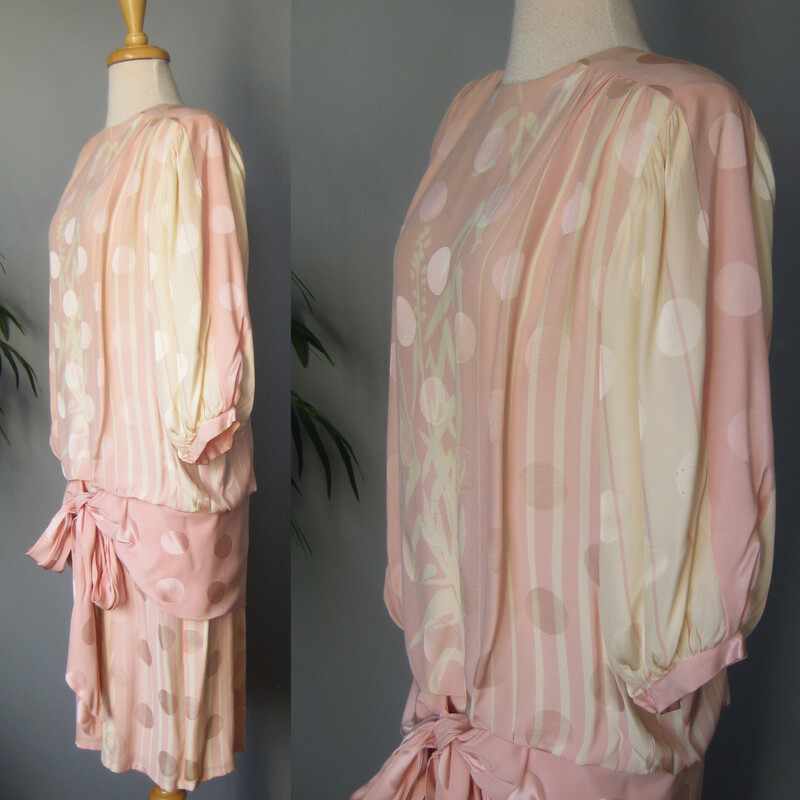 Vtg St Rome Silk Drop Wst, Pink, Size: 12<br />
Pastel pink and yellow evening dress from the 1980s by Saint Romei<br />
The dress was made in the 1980s in Korea.<br />
The silk has a slightly gauzy feel and it's jacquard with big circles woven into the fabric and a complicated but subtle floral print.<br />
It has big shoulders (with pads) and is slim through the hips.<br />
The silhouette is reinforced with low set ties.<br />
Silk covered buttons at the back and the cuffs<br />
(one of the cuff buttons is a plain plastic replacement)<br />
The sleeves will come to about the elbow.<br />
CONDITION: I found one faint stain on the front.  I did not try to do anything to it for fear of making it worse and I feel it's not really noticeable unless upon close inspection.<br />
Makred size 12<br />
Here are the flat measurements, please double where appropriate:<br />
Shoulder to shoulder: 16<br />
Armpit to Armpit: 24.5<br />
Waist: free<br />
Hips: 18.5<br />
Length from back of neck to hem: 42.5<br />
<br />
Thank you for looking.<br />
#76774