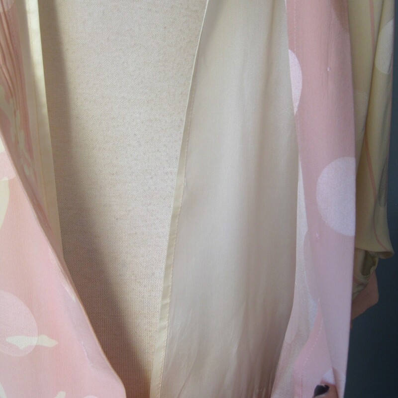 Vtg St Rome Silk Drop Wst, Pink, Size: 12
Pastel pink and yellow evening dress from the 1980s by Saint Romei
The dress was made in the 1980s in Korea.
The silk has a slightly gauzy feel and it's jacquard with big circles woven into the fabric and a complicated but subtle floral print.
It has big shoulders (with pads) and is slim through the hips.
The silhouette is reinforced with low set ties.
Silk covered buttons at the back and the cuffs
(one of the cuff buttons is a plain plastic replacement)
The sleeves will come to about the elbow.
CONDITION: I found one faint stain on the front.  I did not try to do anything to it for fear of making it worse and I feel it's not really noticeable unless upon close inspection.
Makred size 12
Here are the flat measurements, please double where appropriate:
Shoulder to shoulder: 16
Armpit to Armpit: 24.5
Waist: free
Hips: 18.5
Length from back of neck to hem: 42.5

Thank you for looking.
#76774