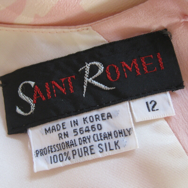 Vtg St Rome Silk Drop Wst, Pink, Size: 12<br />
Pastel pink and yellow evening dress from the 1980s by Saint Romei<br />
The dress was made in the 1980s in Korea.<br />
The silk has a slightly gauzy feel and it's jacquard with big circles woven into the fabric and a complicated but subtle floral print.<br />
It has big shoulders (with pads) and is slim through the hips.<br />
The silhouette is reinforced with low set ties.<br />
Silk covered buttons at the back and the cuffs<br />
(one of the cuff buttons is a plain plastic replacement)<br />
The sleeves will come to about the elbow.<br />
CONDITION: I found one faint stain on the front.  I did not try to do anything to it for fear of making it worse and I feel it's not really noticeable unless upon close inspection.<br />
Makred size 12<br />
Here are the flat measurements, please double where appropriate:<br />
Shoulder to shoulder: 16<br />
Armpit to Armpit: 24.5<br />
Waist: free<br />
Hips: 18.5<br />
Length from back of neck to hem: 42.5<br />
<br />
Thank you for looking.<br />
#76774