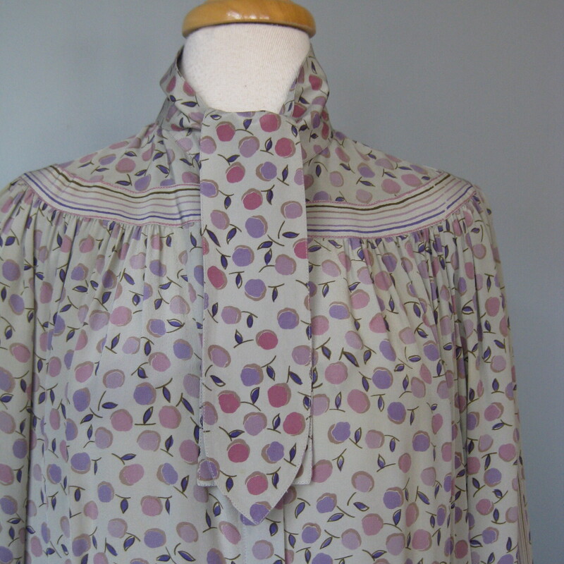 Francesca Damon Silk, Gray, Size: 10<br />
Here is a pretty silk dress is soft grays and lavender with a subtle floral print.<br />
It's from the 1980s.<br />
by Francesca Damon for Starington and it was purchased at Neiman Marcus.<br />
Made in Hong Kong<br />
The dress has hidden buttons all the way down the front.<br />
It has a high collar with attached sash ties.<br />
It comes with a matching sash, wider than the neck ties but not long enough to serve as a belt.<br />
Unlined<br />
Pockets<br />
Long sleeves with button cuffs<br />
small shoulder pads.<br />
it's marked size 10 but use these measurements to be sure it will fit. It seems like it will fit larger than a modern size 10.<br />
Flat measurements:<br />
Shoulder to shoulder: 14.5<br />
armpit to armpit: 23.5<br />
Waist: 24<br />
Hip: up to 25<br />
Length: 44<br />
Underarm sleeve seam: 19 (sleeve buttons at the end)<br />
<br />
perfect condition!<br />
<br />
Thanks for looking!<br />
#72244