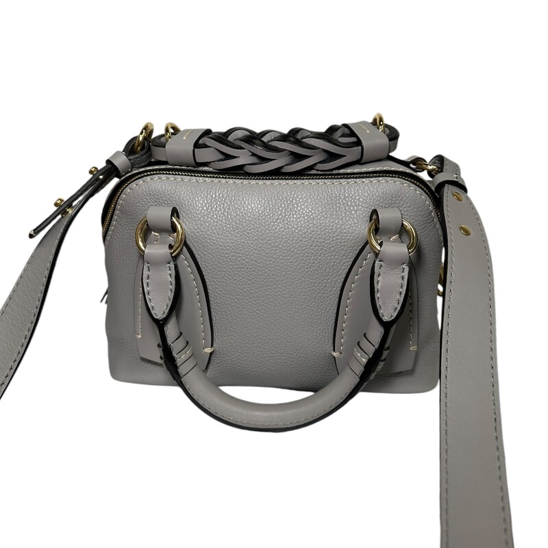 CHLOE Calfskin Small Daria in Stormy Grey. This satchel is crafted of grained calfskin leather in a soft gray. The handbag features a braided leather top handle, rolled leather top handles with oversized leather anchors, an optional adjustable leather shoulder strap, polished gold hardware, and contrasting white stitching. The top zippers open to separate Chloe jacquard fabric interiors.<br />
<br />
Dimensions:<br />
Base length: 9.00 in<br />
Height: 6.00 in<br />
Width: 4.25 in<br />
Drop: 1.50 in<br />
Drop: 3.50 in<br />
Drop: 21.00 in<br />
Code: 0121 7065 07