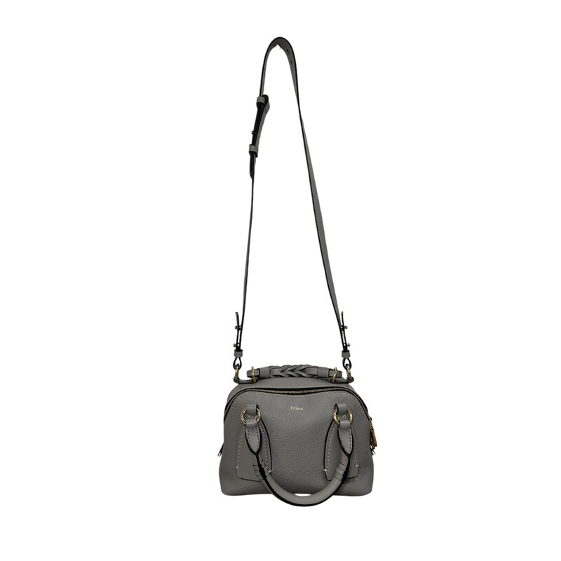 CHLOE Calfskin Small Daria in Stormy Grey. This satchel is crafted of grained calfskin leather in a soft gray. The handbag features a braided leather top handle, rolled leather top handles with oversized leather anchors, an optional adjustable leather shoulder strap, polished gold hardware, and contrasting white stitching. The top zippers open to separate Chloe jacquard fabric interiors.<br />
<br />
Dimensions:<br />
Base length: 9.00 in<br />
Height: 6.00 in<br />
Width: 4.25 in<br />
Drop: 1.50 in<br />
Drop: 3.50 in<br />
Drop: 21.00 in<br />
Code: 0121 7065 07