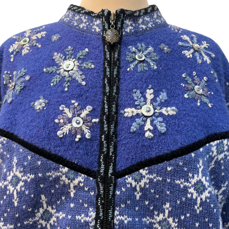 Icelandic Snowflake Zip Cardigan<br />
100% Wool<br />
Button Detail On Snowflakes<br />
Snowflakes on Sleeve Cuffs<br />
Blue and White<br />
Size: Large