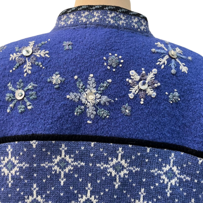 Icelandic Snowflake Zip Cardigan<br />
100% Wool<br />
Button Detail On Snowflakes<br />
Snowflakes on Sleeve Cuffs<br />
Blue and White<br />
Size: Large