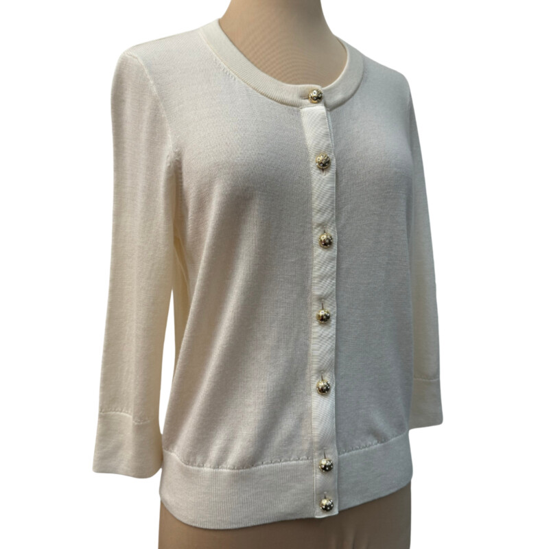 Kate Spade Wool Cardigan<br />
Bejeweled Buttons<br />
Ribbon Accent<br />
3/4 Sleeve<br />
100% Wool<br />
Color: Cream<br />
Size: Medium