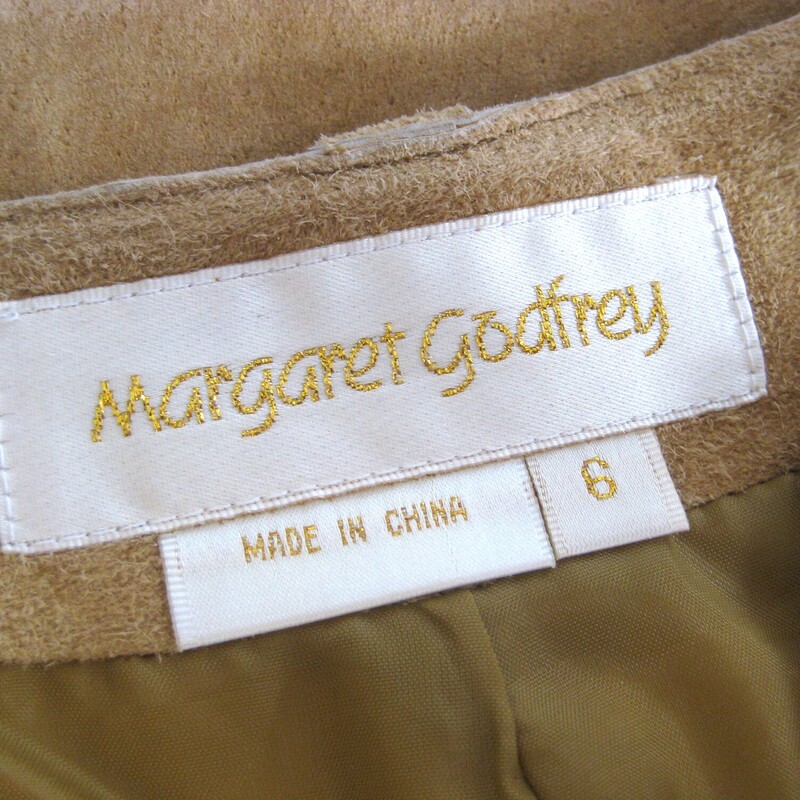 Here is a great separate for your vintage wardrobe.  It's a warm beige midi skirt in suede by Margaret Godfrey.<br />
simple with a front fly (zipper and slide hook and eye) and button loops at the top.<br />
Fully lined<br />
Heavy!<br />
A super versatile piece in super shape.<br />
Here are the flat measurements, please double where appropriate:<br />
Marked size 6 but best for a size 4 imo<br />
Waist: 15.25<br />
Hips: 20.5<br />
Length: 37.25<br />
<br />
Thank you for looking.<br />
#79838