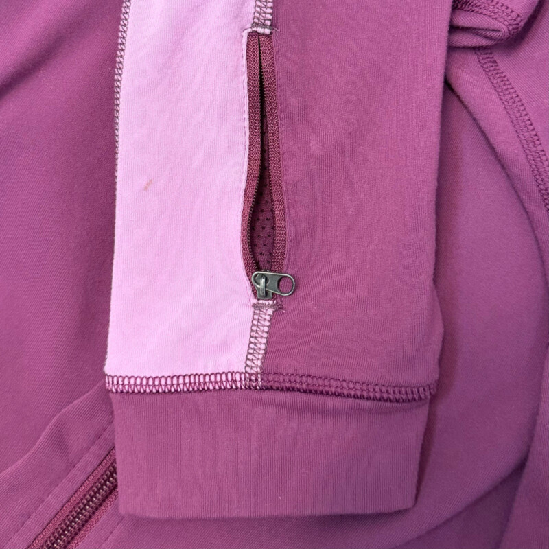 Lululemon Zip Jacket<br />
Colorblock Design<br />
Zipper Pocket on Sleeve<br />
Lavender and Lilac<br />
Size: Medium