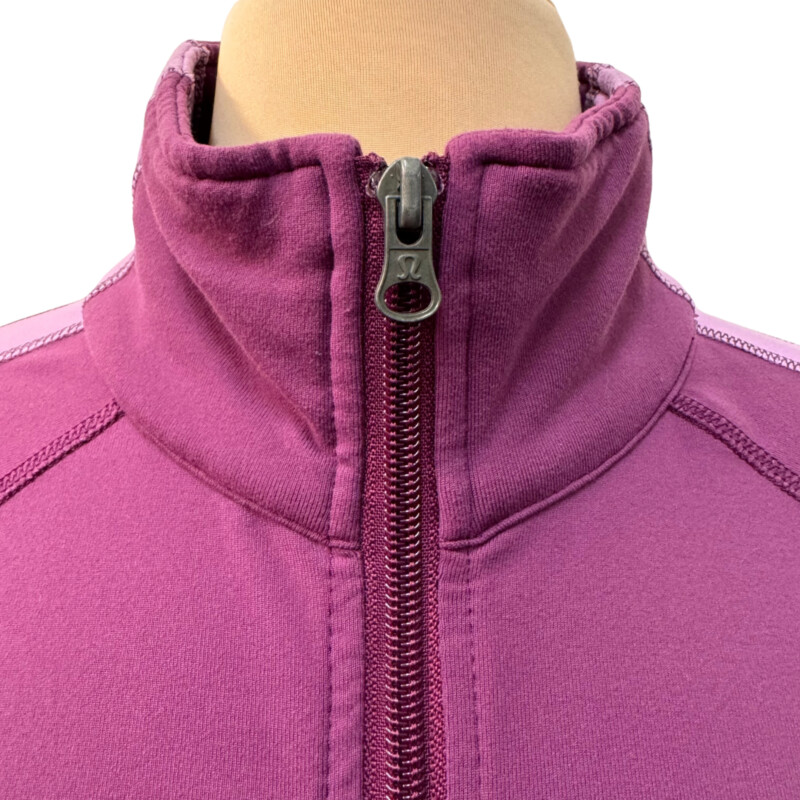 Lululemon Zip Jacket<br />
Colorblock Design<br />
Zipper Pocket on Sleeve<br />
Lavender and Lilac<br />
Size: Medium