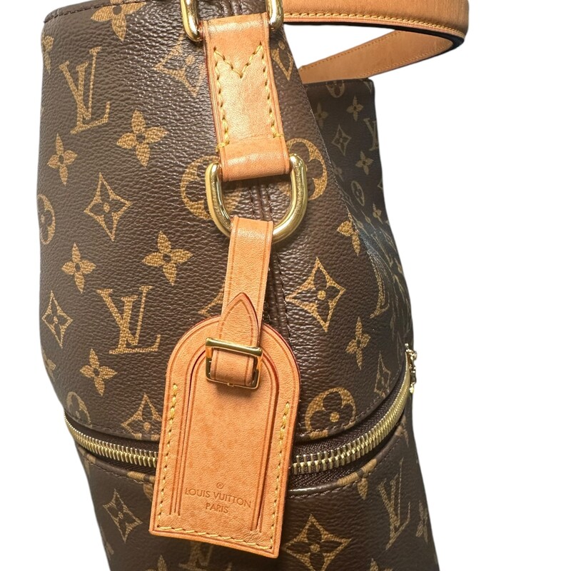 LOUIS VUITTON Monogram Melie. This chic hobo bag is finely crafted of classic Louis Vuitton monogram coated canvas in brown. The bag features zipper pockets on either side, a vachetta leather top handle, and a removable, adjustable vachetta leather shoulder strap with polished gold hardware. The top is open to a deep purple microfiber interior with patch pockets.<br />
Dimensions:<br />
Base length: 12 in<br />
Height: 13.75 in<br />
Width: 4.5 in<br />
Drop: 3.5 in<br />
Drop: 14 in<br />
Date Code: SA0188<br />
<br />
Some water marks on tag shown in photo.