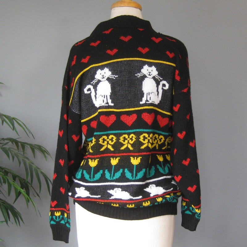 Super cute cat sweater for you or your favorite cat loving friend<br />
It's black with rows of images including Cats, mice, tulips and hearts.<br />
It's by Adele<br />
made in the USA<br />
Acrylic with a bit of lurex<br />
Should fit a modern size large or oversize for a medium<br />
Here are the flat measurements:<br />
Shoulder to Shoulder: 22.25<br />
Armpit to Armpit: 21.5<br />
Width at Hem: 17<br />
length: 24.25<br />
Underarm sleeve seam length: 19<br />
<br />
Excellent condition.<br />
Thanks for looking!<br />
#79244