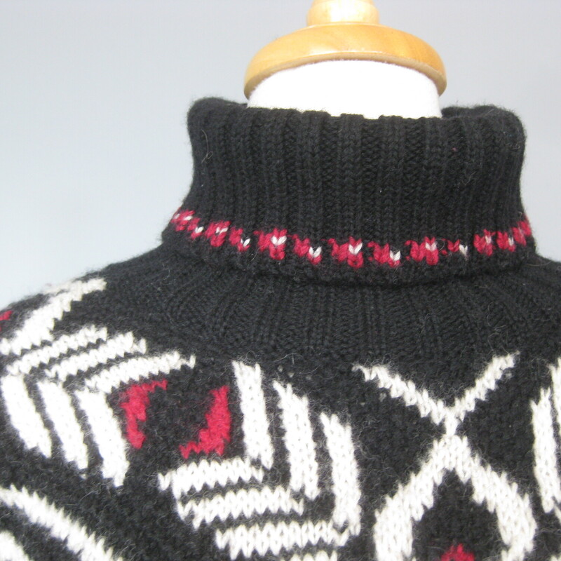 Wool hand knitted sweater from Jones NY<br />
Wintery black, red and white ski style pattern.<br />
Turtle or mock turtle neck<br />
It has 2 silver metal buttons at the bottom of each side seam that can be opened for a little more room at the hem.<br />
Marked size medium, might fit a modern size large as well.<br />
flat measurements:<br />
Shoulder to shoulder: 22<br />
armpit to armpit: 21.5<br />
width at hem: 22<br />
underarm sleeve seam: 19.5<br />
length: 27<br />
thanks for looking!<br />
#79144