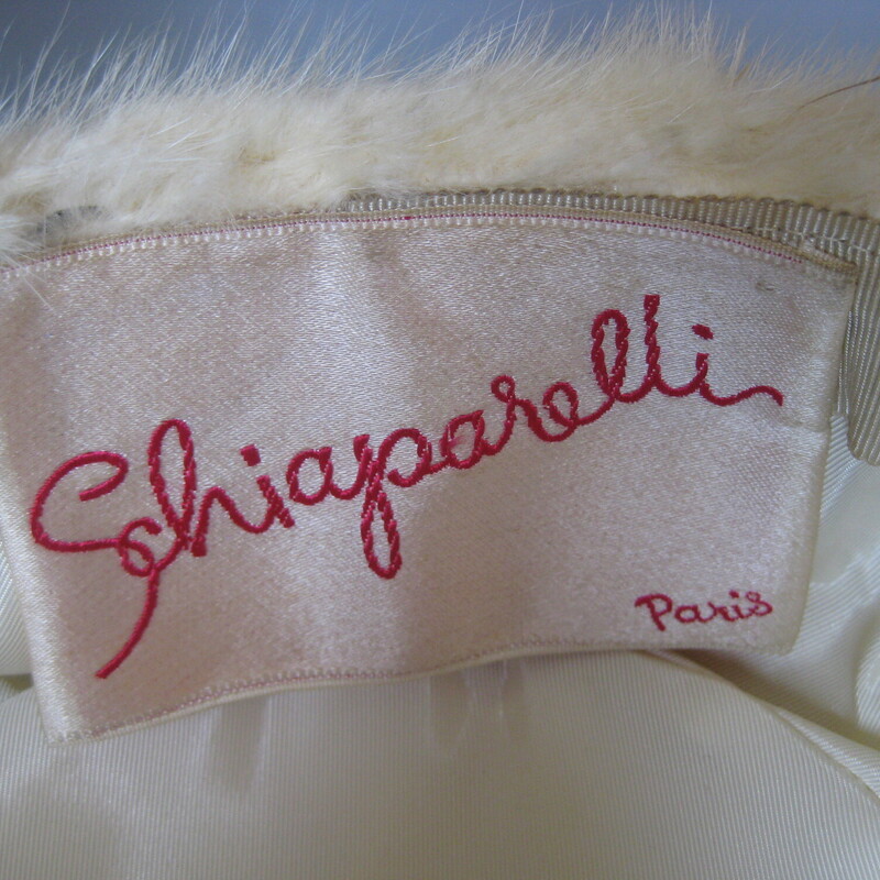 Gorgeous 1950s fur pillbox hat.  I believe it is white mink.<br />
It was made by famous design house Schiaraperelli.<br />
The hat has an elegant folded satin top and lining<br />
<br />
It measures aproximately 20.5 around on the inside.  This hat may be perched more on the back of the head than straight on.<br />
Excellent vintage condition.<br />
perfect condtion.<br />
Thank you for looking.<br />
#80082