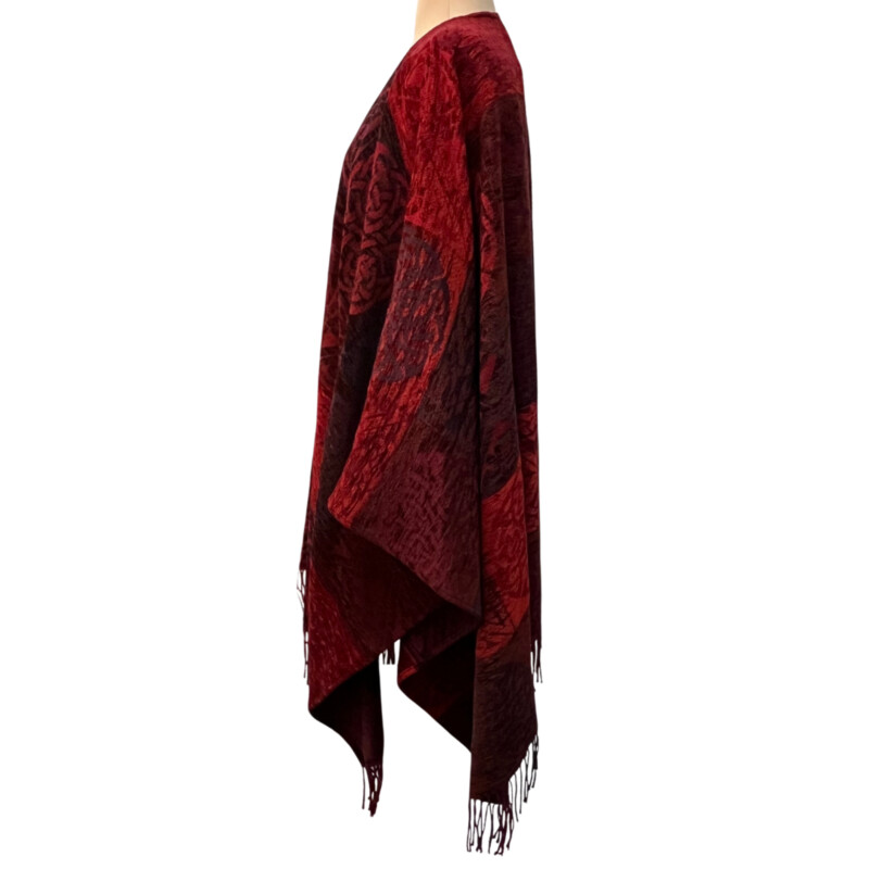 New Calzeat Celtic Ruana<br />
New With Tags<br />
Woven Celctic Design<br />
Wool Blend with Fringe Detail<br />
Designed and Woven in Scotland<br />
Colors:  Red and Plum<br />
Retails for $161.00