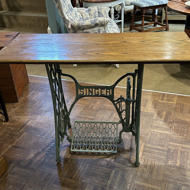 Singer Sewing Base Table,
Size: 42x18x29
Original Singer Sewing machine base with working tredle, that is painted a soft vintage green.  Finished oak top with beveled edges.