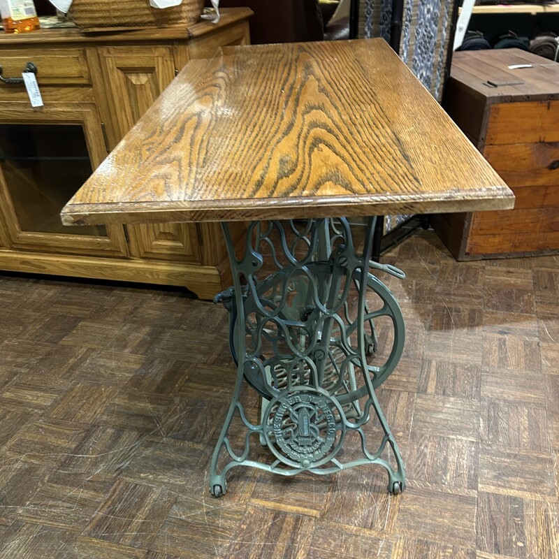 Singer Sewing Base Table,
Size: 42x18x29
Original Singer Sewing machine base with working tredle, that is painted a soft vintage green.  Finished oak top with beveled edges.