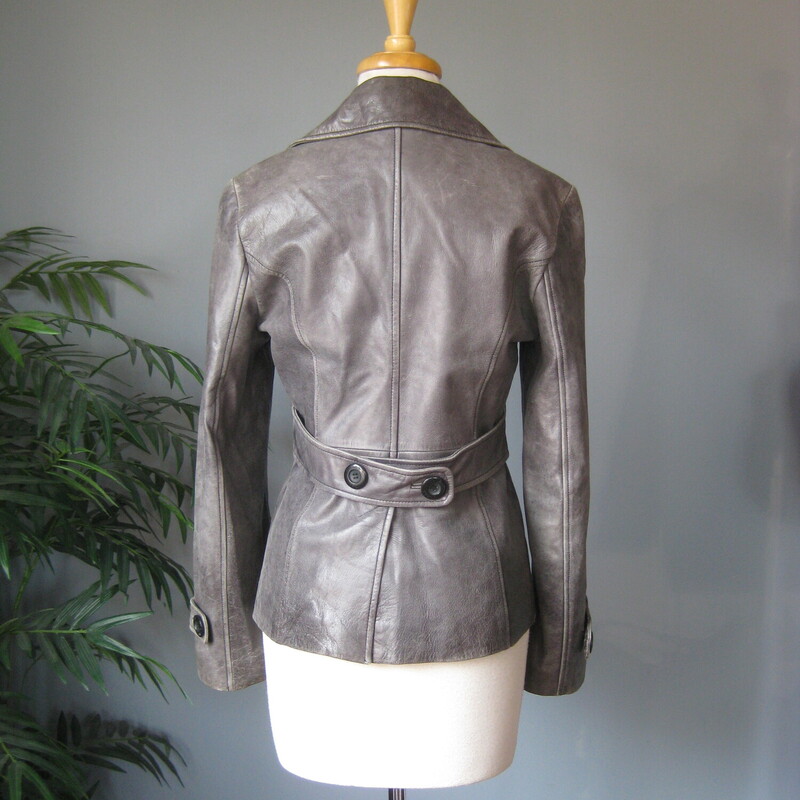 Guess Leather Moto, Gray, Size: Medium<br />
This simple hip length double breasted gray leather jacket has a bit of an edge but wearable to work and any other occasion.  Trench details, peacoat adjacet it's fully line with side pockets and straps at the end of the cuffs.<br />
Button closures<br />
It has pockets and a high and wide notched lapel<br />
<br />
Excellent pre-owned condition!<br />
It's marked size M, but I am calling it a small.  The measurements, as you will see are too small for a modern size M, I am a size medium and I tried it on and it was too snug for me all over.<br />
<br />
Here are the flat measurements:<br />
Shoulder to shoulder: 15.75<br />
Armpit to armpit: 19.5<br />
Width at hem: 18<br />
Length: 25<br />
underarm sleeve seam: 17<br />
<br />
Thanks for looking!<br />
#80698