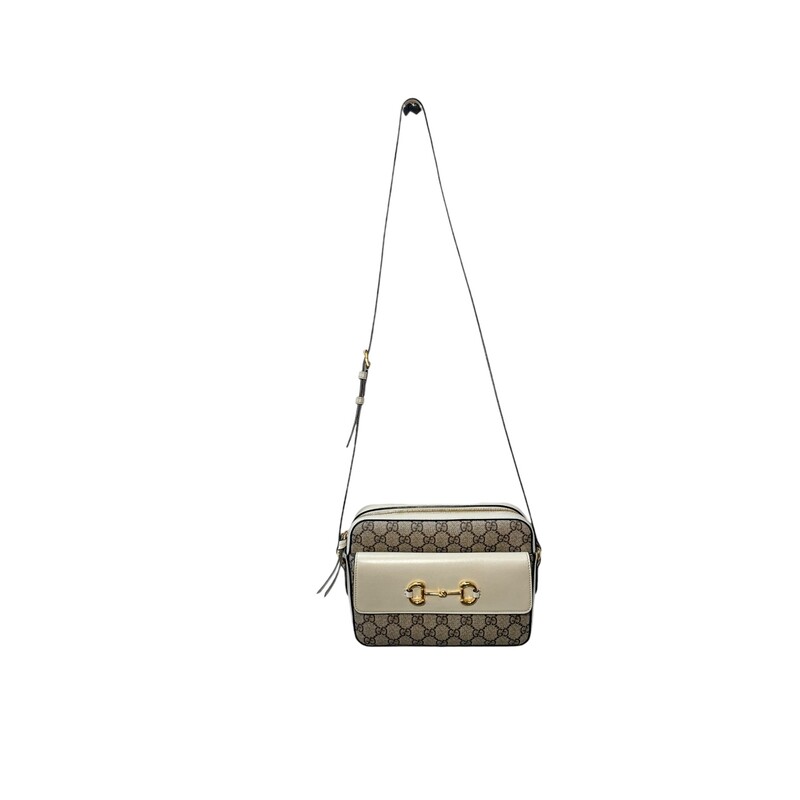 GUCCI GG Supreme Monogram Small Horsebit 1955 Shoulder Bag in Beige and Mystic White.<br />
This  shoulder bag is crafted of classic Gucci monogram GG supreme canvas with off white leather trim. The bag features a looping leather shoulder strap and front flap with a gold horse-bit detail. The top flap opens to a beige fabric interior with a zipper pocket.<br />
<br />
Style Code: 645454 520981<br />
<br />
Dimensions:<br />
Base length: 8.75 in<br />
Height: 6.5 in<br />
Width: 2.25 in<br />
Drop: 22 in<br />
<br />
Condition: Some minimal wear on bottom.<br />
<br />
Comes with original dust bag and box.