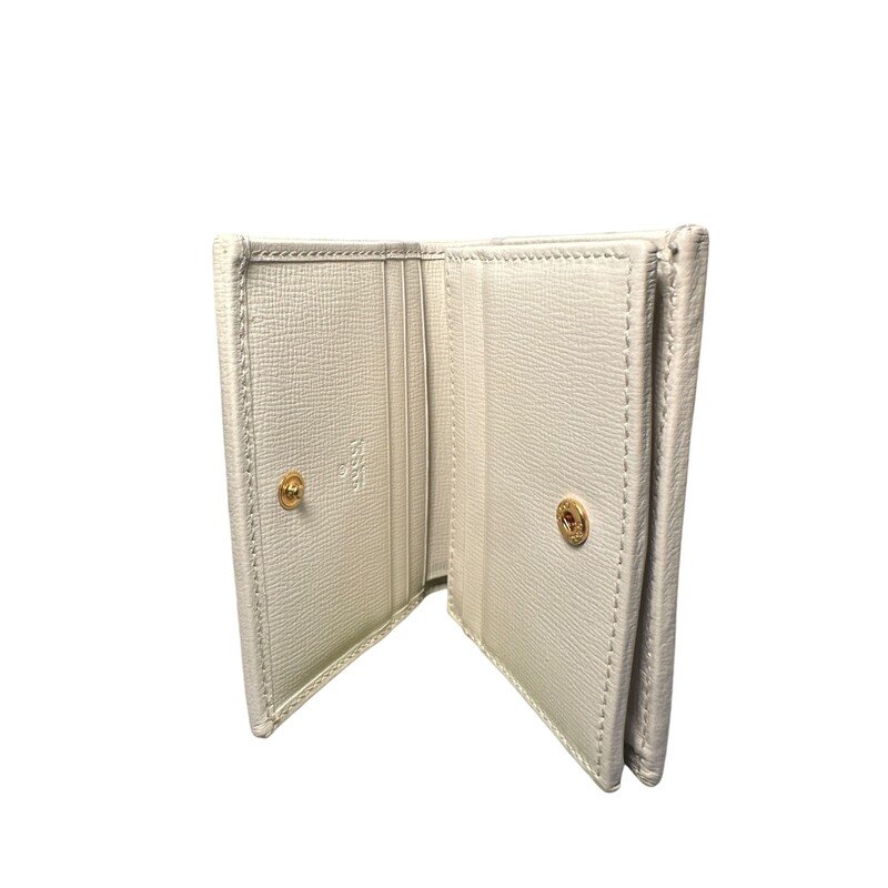 Gucci Horsebit 1955 Wallet<br />
Beige/ebony GG Supreme canvas<br />
White leather details<br />
Gold-toned hardware<br />
Viscose lining<br />
Horsebit detail<br />
Inside: 5 card slots, open pocket, 1 zipper pocket, 1 bill compartment<br />
Snap button closure<br />
Open: 4.3W x 6.9H<br />
Closed: 4.3W x 3.3H x 1.2D<br />
Made in Italy<br />
<br />
Condition: Like New<br />
Style code:621887.0416<br />
<br />
Comes with original box and dust bag.