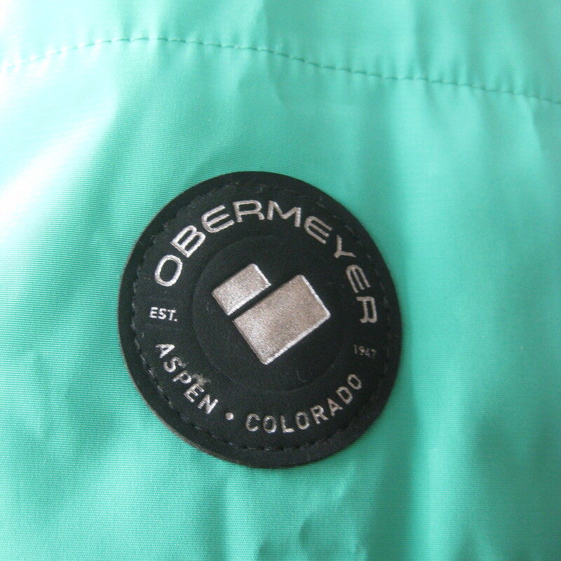 Obermyer Puffer Fur Hood, Green, Size: 8<br />
purchased last year.<br />
It was a warm winter.<br />
Only worn a few time.<br />
Obermeyer ski coat<br />
bright light green<br />
with a removeable fur trimmed hood. Attaches with easy on/off snaps<br />
zippered pockets on the sides<br />
interior is lined with black and white paisley fabric<br />
The lining has a loose flap which you can cinch close on windy days to keep the wind from zooming up from the bottom.<br />
Marked size 8.<br />
IMO, it's a little bit of a small size 8<br />
flat measurements, taken on the OUTSIDE of the jacket.<br />
shoulder to shoulder: 15.75<br />
armpit to armpit: 20.5<br />
width at hem: 19<br />
underarm sleeve seam: 19.5<br />
length: 26<br />
<br />
excellent like new condition!<br />
Thanks for looking!<br />
#80720