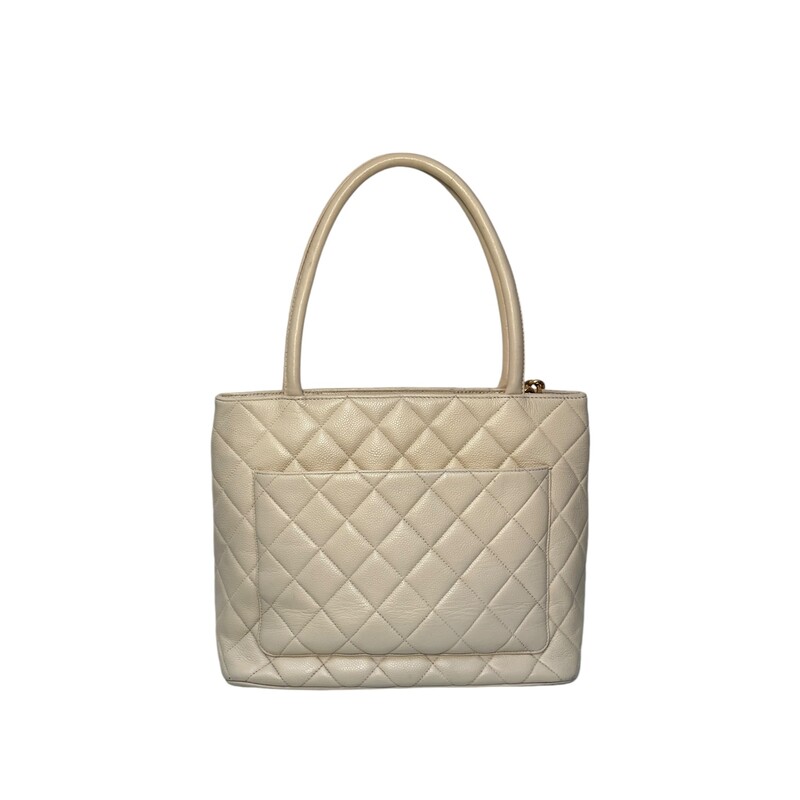 Chanel Medallion Cream Tote<br />
<br />
Note: Wear to corners. Light wear to upper leather trim.<br />
<br />
Date Code: 4826275<br />
<br />
Dimensions:<br />
Handle Drop: 6<br />
Height: 10.25<br />
Width: 11<br />
Depth: 5.75