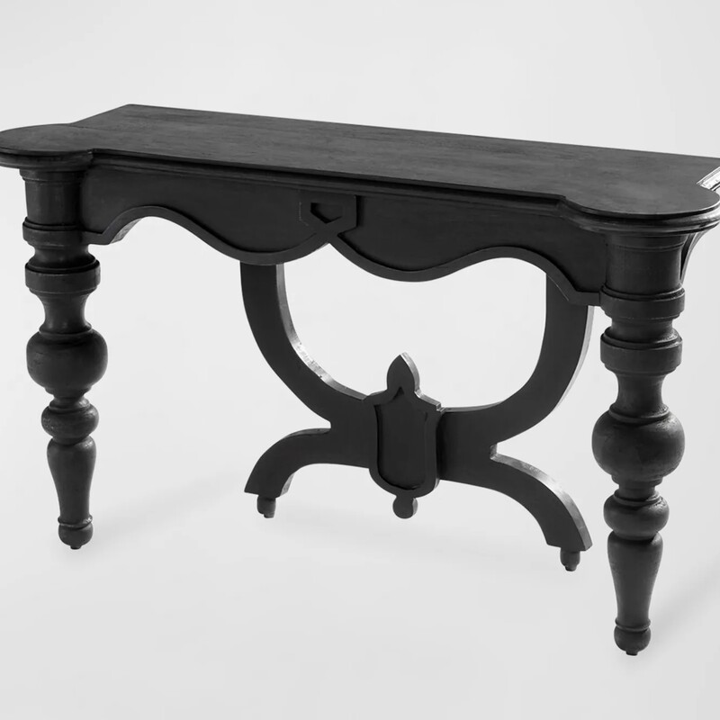 Cyan Lola Console Table

Size: 54Wx18Dx32H

The Lola Console Table comprises solid wood, coated in a slate black finish with hand-carved accents. The base's traditional formation is formed by two decorative front leg pillars and a single ornate back brace leg. Adorn your transitional entryway or complete your living room styling.