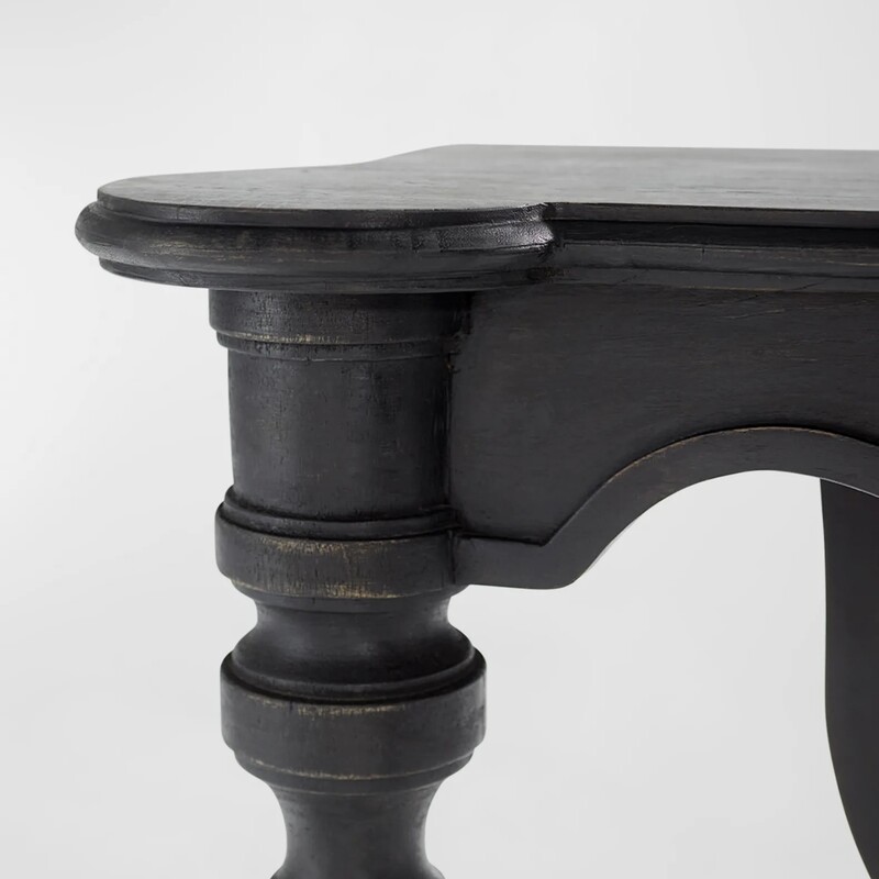 Cyan Lola Console Table<br />
<br />
Size: 54Wx18Dx32H<br />
<br />
The Lola Console Table comprises solid wood, coated in a slate black finish with hand-carved accents. The base's traditional formation is formed by two decorative front leg pillars and a single ornate back brace leg. Adorn your transitional entryway or complete your living room styling.