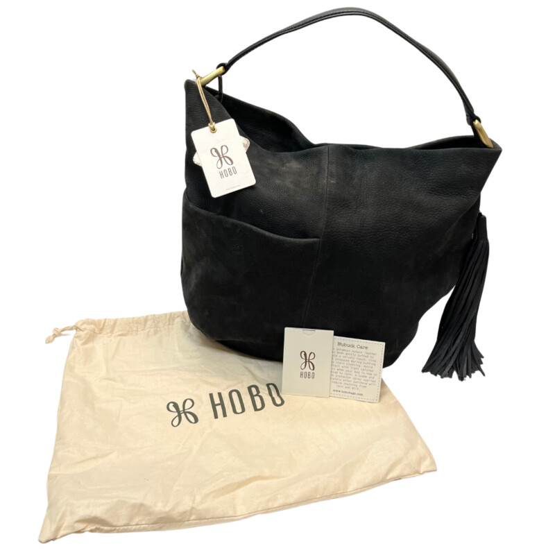 New Hobo Meridian Black Handbag<br />
A bohemian-inspired hobo silhouette made for women who love oversized, slouchy, relaxed bags. Crafted in in velvet hide, the leather is irresistibly soft and falls in a natural, carefree way.<br />
Old English Brass hardware<br />
Zip closure<br />
Exterior: Side zip pocket, back slip pocket with hidden magnet closure<br />
Interior: 2 slip pockets and zip pocket with slip and pen pocket on top<br />
fits up to iph7+<br />
Wanderlust lining<br />
Polyester Interior