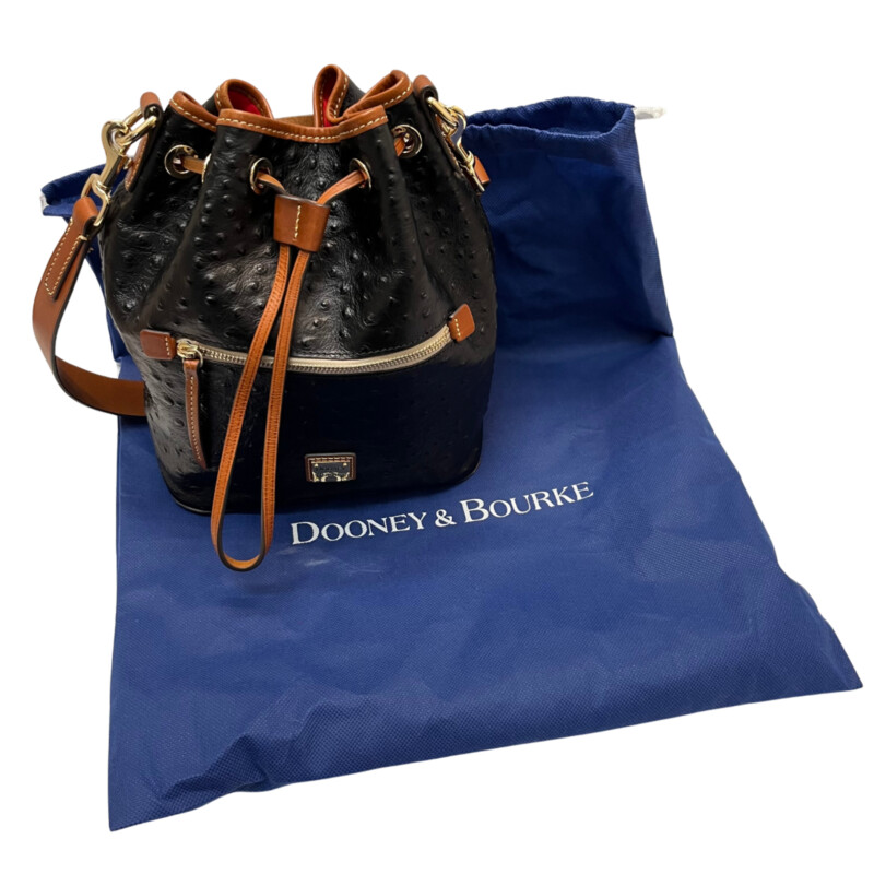 Dooney&Bourke  Ostrich Drawstring Handbag<br />
Embossed calfskin leather<br />
Drawstring closure.<br />
Detachable Shoulder strap. Strap drop length: 13.<br />
H 10.5 x W 5.25 x L 8.75<br />
1 lb 9 oz<br />
Designed in Norwalk, CT by Peter Dooney.<br />
One outside zip pocket. One inside zip pocket. Two inside pockets.<br />
Cell phone pocket.<br />
Inside key hook.<br />
Lined.<br />
Feet.<br />
Color: Black, and Tan