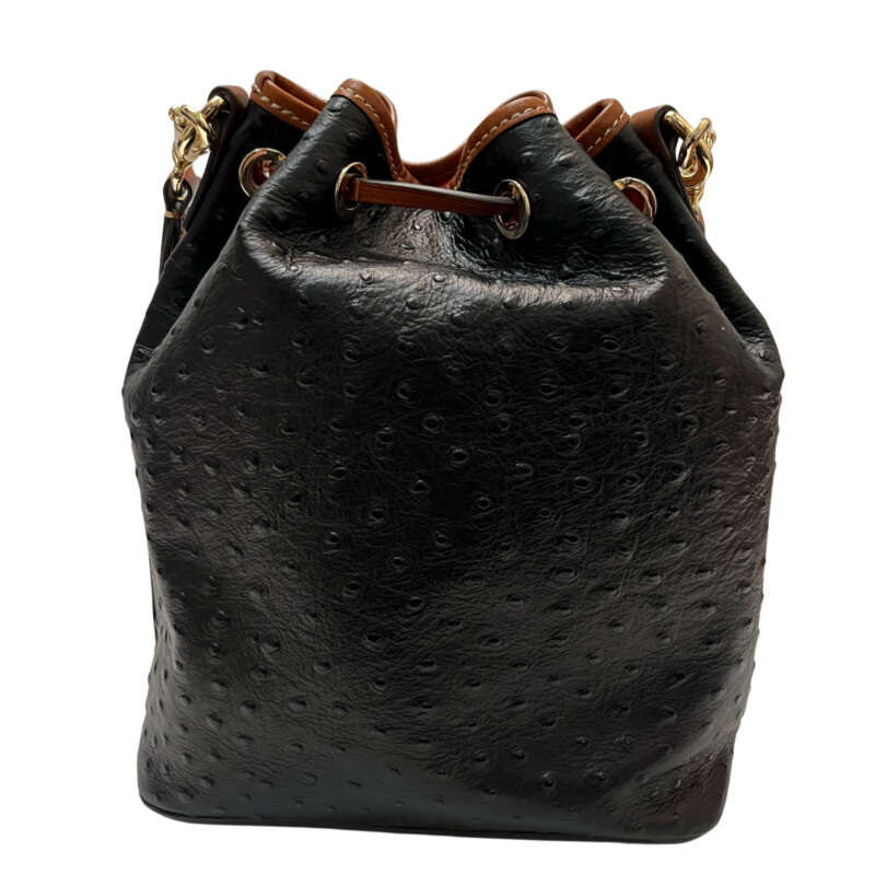 Dooney&Bourke  Ostrich Drawstring Handbag<br />
Embossed calfskin leather<br />
Drawstring closure.<br />
Detachable Shoulder strap. Strap drop length: 13.<br />
H 10.5 x W 5.25 x L 8.75<br />
1 lb 9 oz<br />
Designed in Norwalk, CT by Peter Dooney.<br />
One outside zip pocket. One inside zip pocket. Two inside pockets.<br />
Cell phone pocket.<br />
Inside key hook.<br />
Lined.<br />
Feet.<br />
Color: Black, and Tan