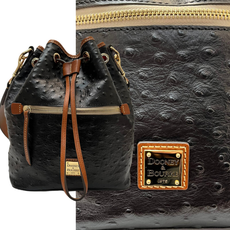 Dooney&Bourke  Ostrich Drawstring Handbag
Embossed calfskin leather
Drawstring closure.
Detachable Shoulder strap. Strap drop length: 13.
H 10.5 x W 5.25 x L 8.75
1 lb 9 oz
Designed in Norwalk, CT by Peter Dooney.
One outside zip pocket. One inside zip pocket. Two inside pockets.
Cell phone pocket.
Inside key hook.
Lined.
Feet.
Color: Black, and Tan