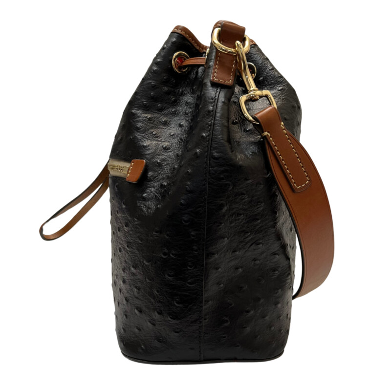 Dooney&Bourke  Ostrich Drawstring Handbag<br />
Embossed calfskin leather<br />
Drawstring closure.<br />
Detachable Shoulder strap. Strap drop length: 13.<br />
H 10.5 x W 5.25 x L 8.75<br />
1 lb 9 oz<br />
Designed in Norwalk, CT by Peter Dooney.<br />
One outside zip pocket. One inside zip pocket. Two inside pockets.<br />
Cell phone pocket.<br />
Inside key hook.<br />
Lined.<br />
Feet.<br />
Color: Black, and Tan