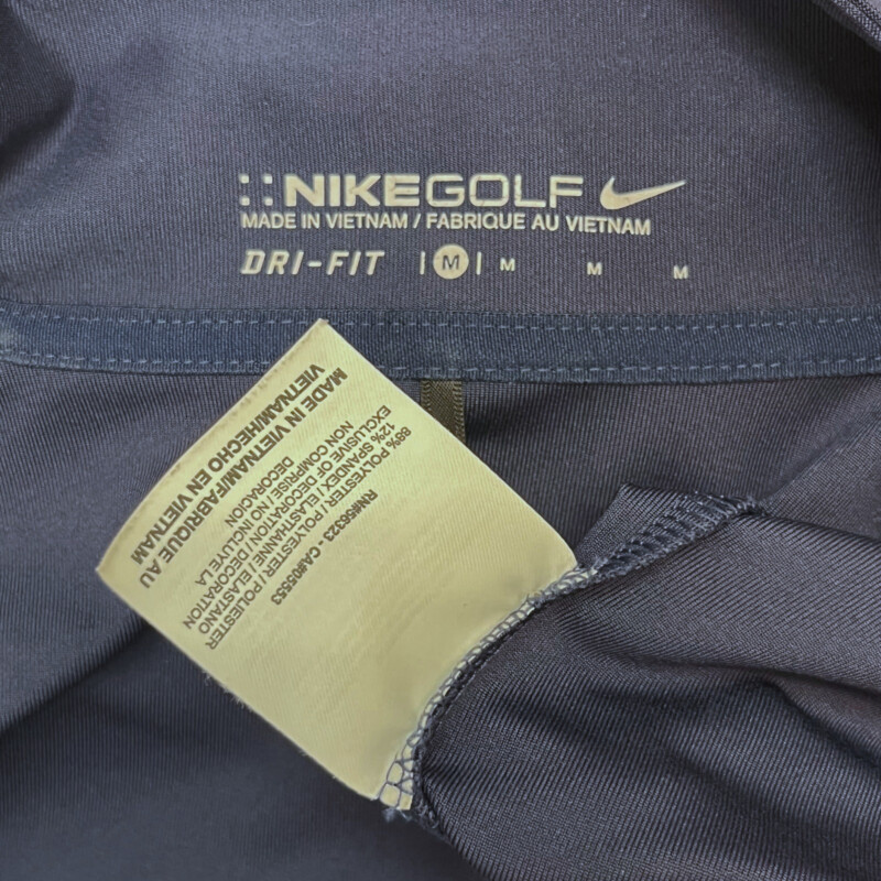 Nike Zip Pullover<br />
NIke Golf<br />
Dry Fit<br />
Ribbon detail on sleeve<br />
Cinched<br />
Color: Navy, and White<br />
Size: Medium