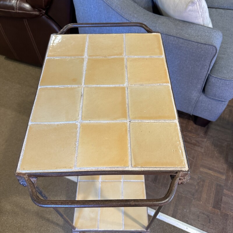 Double Tile Top Table,<br />
 Size: 22.5x13x36<br />
Lovely pale yellow tile on top and bottom encased in heavy metal frame.  This woud be a great table in the kitchen or on the sunporch.  It will not tip over easily!<br />
Excellent condition