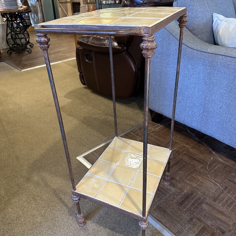 Double Tile Top Table,<br />
 Size: 22.5x13x36<br />
Lovely pale yellow tile on top and bottom encased in heavy metal frame.  This woud be a great table in the kitchen or on the sunporch.  It will not tip over easily!<br />
Excellent condition