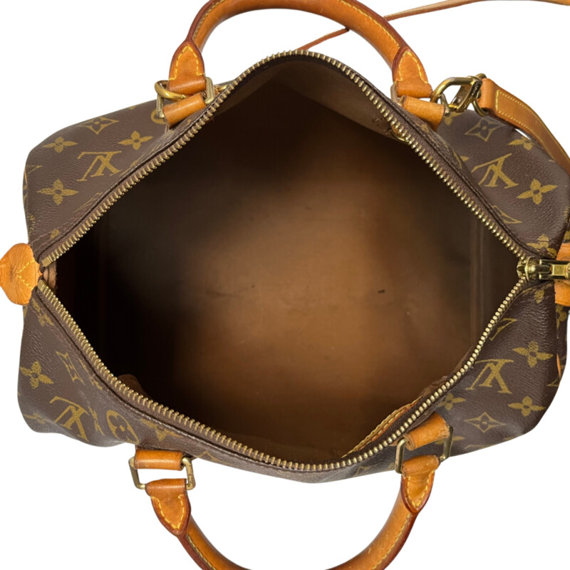 Louis Vuitton Speedy 30 Handbag<br />
Quality Made Leather with Monogram Print<br />
Top Handle Bag with Strap<br />
From the 1991 Collection<br />
Brown Coated Canvas<br />
Brass Hardware<br />
Rolled Handles<br />
Leather Trim Embellishment<br />
Canvas Lining & Single Interior Pocket<br />
Zip Closure at Top