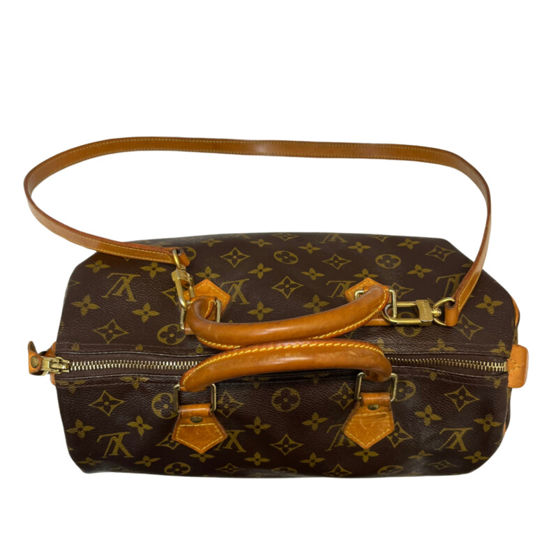 Louis Vuitton Speedy 30 Handbag<br />
Quality Made Leather with Monogram Print<br />
Top Handle Bag with Strap<br />
From the 1991 Collection<br />
Brown Coated Canvas<br />
Brass Hardware<br />
Rolled Handles<br />
Leather Trim Embellishment<br />
Canvas Lining & Single Interior Pocket<br />
Zip Closure at Top