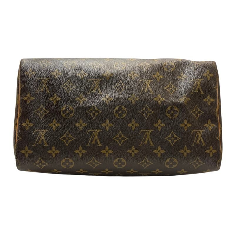 Louis Vuitton Speedy 30 Handbag<br />
Quality Made Leather with Monogram Print<br />
Top Handle Bag with Strap<br />
From the 1991 Collection<br />
Brown Coated Canvas<br />
Brass Hardware<br />
Rolled Handles<br />
Leather Trim Embellishment<br />
Canvas Lining & Single Interior Pocket<br />
Zip Closure at Top