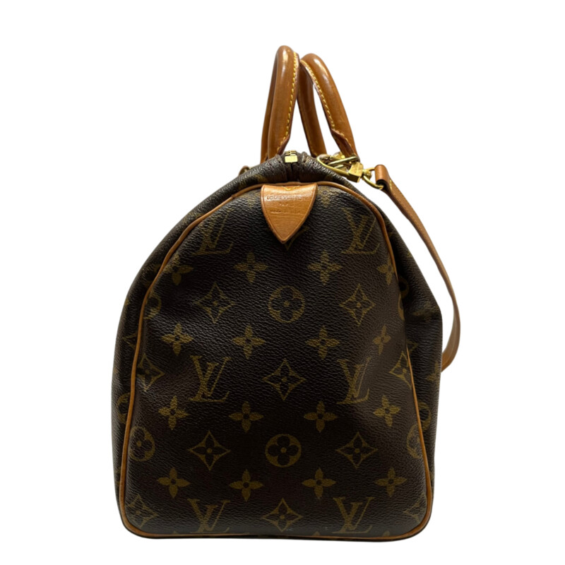 Louis Vuitton Speedy 30 Handbag<br />
Quality Made Leather with Monogram Print<br />
Top Handle Bag with Strap<br />
From the 1991 Collection<br />
Brown Coated Canvas<br />
Brass Hardware<br />
Rolled Handles<br />
Leather Trim Embellishment<br />
Canvas Lining & Single Interior Pocket<br />
Zip Closure at Top